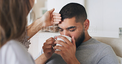 Buy stock photo Sick, man and fever with drink at house for temperature, virus problem and flu symptoms. Couple, check forehead and monitor illness of male person, viral infection and herbal tea for recovery remedy