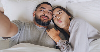 Buy stock photo Morning, couple and selfie with goofy face, smile and love for romance in bedroom. Above man, woman and funny with honeymoon memory, photography and hotel room for vacation and social media post