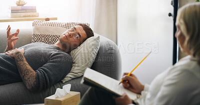 Buy stock photo Writing, psychologist and sofa with man in counseling session for mental health, assessment and support. Patient report, therapy diagnosis and treatment plan with people in office for healing
