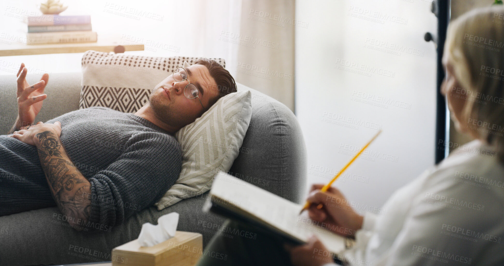 Buy stock photo Writing, psychologist and sofa with man in counseling session for mental health, assessment and support. Patient report, therapy diagnosis and treatment plan with people in office for healing