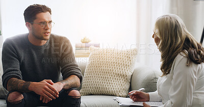 Buy stock photo Chat, therapy and people on sofa in counseling session for mental health, assessment and support. Patient report, psychologist diagnosis and treatment plan with man and woman in office for healing