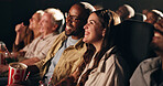 Couple, laugh and happy at cinema for movie in crowd, bonding and date with fast food for comedy show. People, man and woman with smile together, excited or watch comic film with popcorn at theater