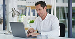 Business, laptop and typing with accountant man at desk in office for financial audit or review. Computer, bookkeeping and finance with employee person in workplace for budget or revenue analysis