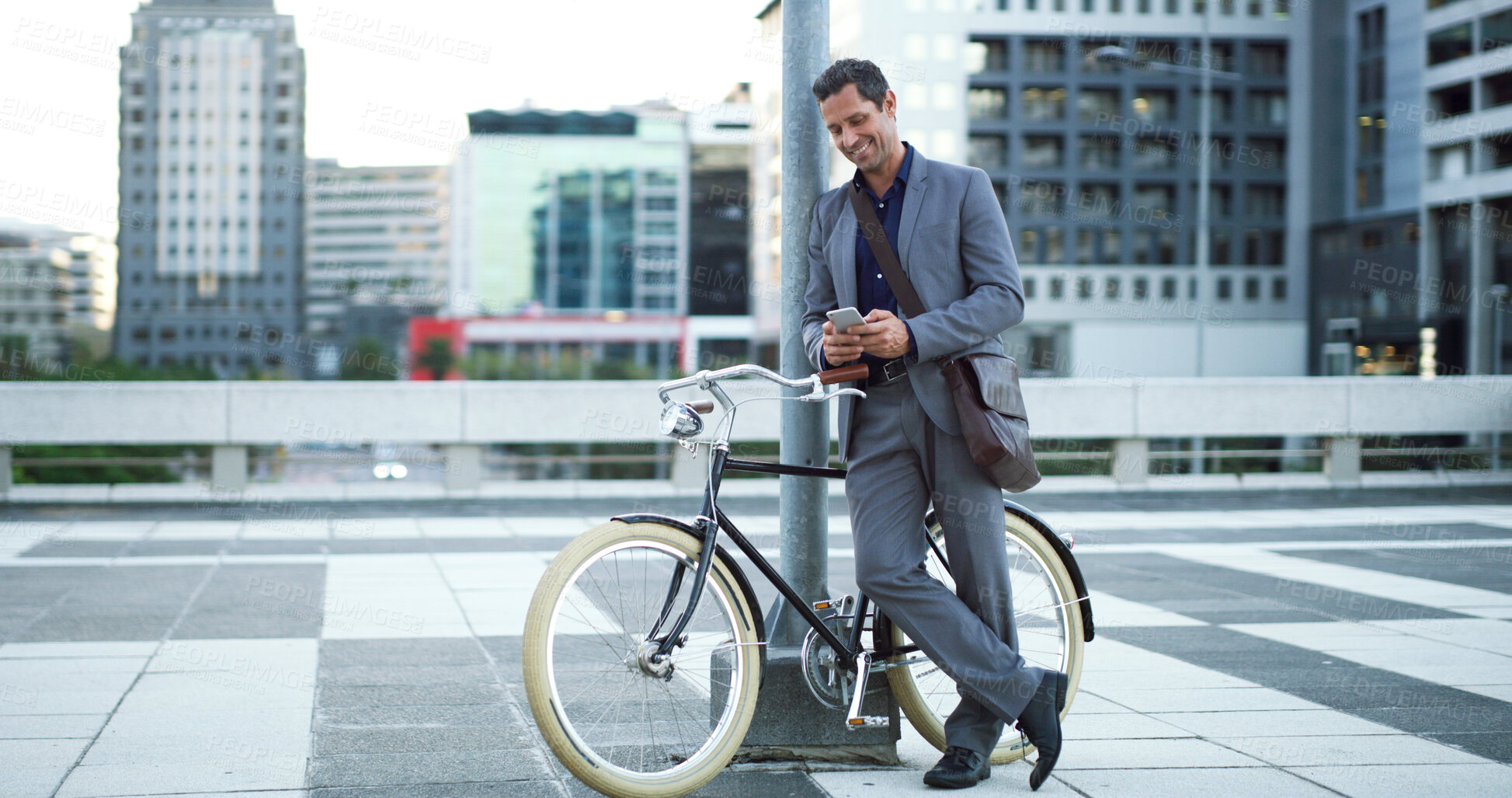 Buy stock photo Bike, phone and text message with businessman in city for eco friendly commute to work location. App, communication and zero emission transport on bicycle with happy employee outdoor in urban town