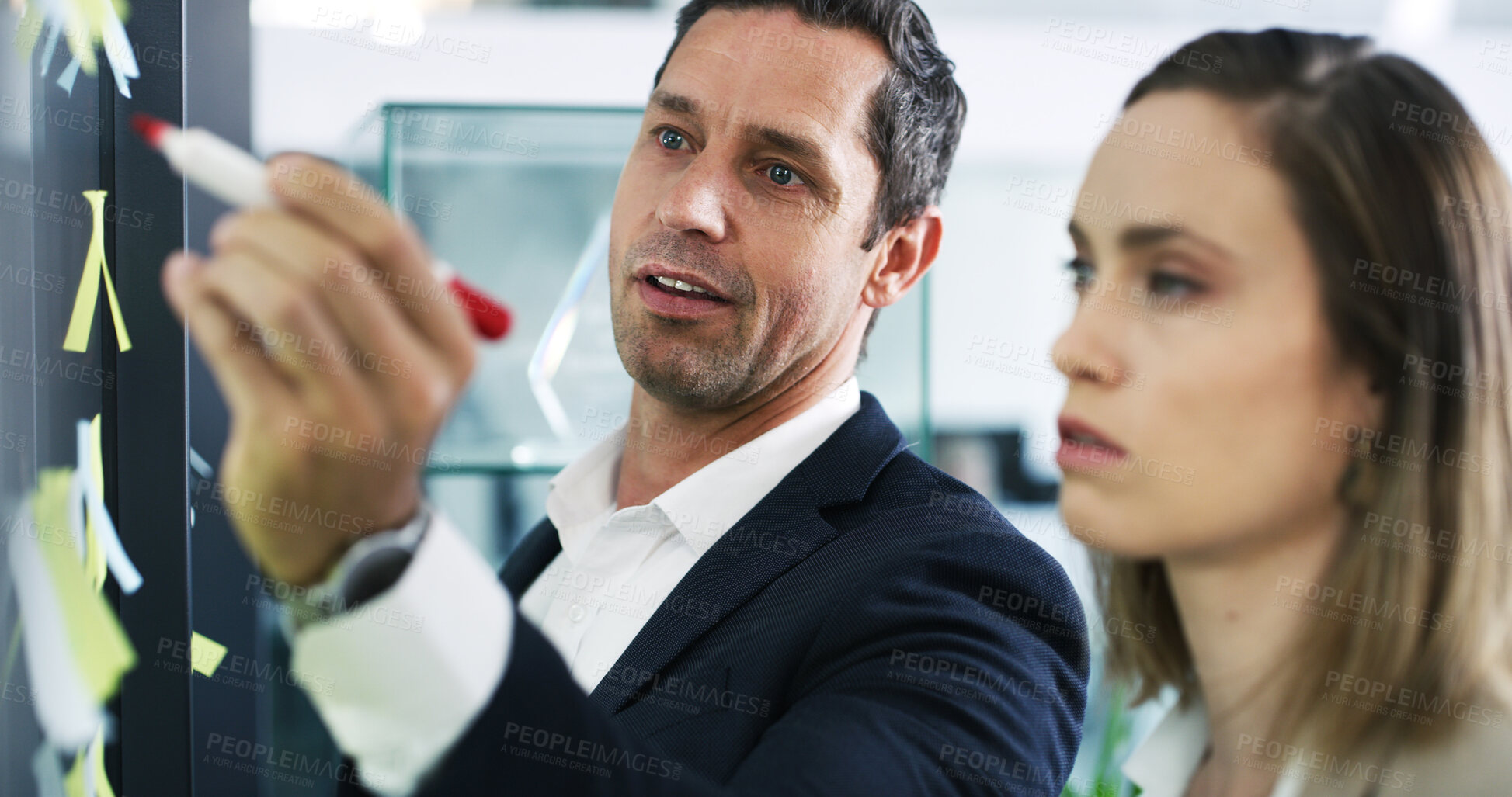 Buy stock photo Wall, leadership and business people writing for schedule planning and brainstorming tasks. Problem solving, coaching or male mentor in startup office for solution, team strategy or project mission