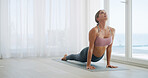 Yoga, stretching and fitness with woman in home for wellness, workout and peace. Balance, relax and pilates exercise with female person on floor in studio for commitment, cobra pose and self care