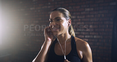 Buy stock photo Woman, earphones and happy at gym with music, listen and thinking with inspiration for training. Person, smile and streaming subscription on break for fitness, exercise and routine at wellness club