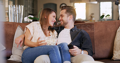 Buy stock photo Popcorn, happy and couple on sofa in home with watching movie, series or show together. Smile, love and man with woman streaming film with snack in living room for date on weekend break in apartment.