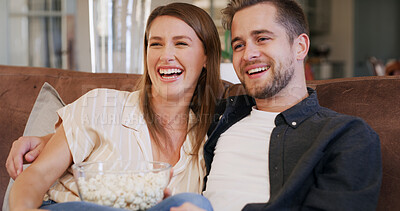 Buy stock photo Couple, popcorn and laughing for comedy movie with streaming or film online for people bonding. Date, relax and hug on sofa with snack for watching tv, funny series or video in living room at home