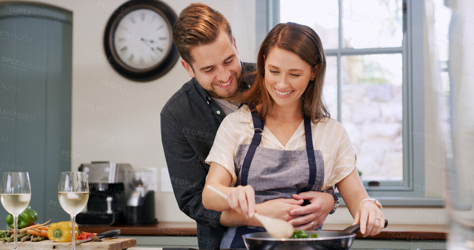 Buy stock photo Couple, hug and support with cooking in kitchen for dinner meal, lunch recipe and bonding. Food, people and embrace with romance in home for dish preparation, nutrition or healthy diet with affection