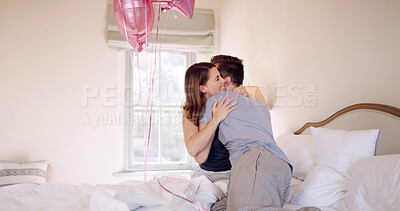 Buy stock photo Happy, couple and hug in bedroom, celebration and bonding on anniversary with balloons in apartment. Romance, man and affection for woman on valentines day, embrace and decoration in house and love