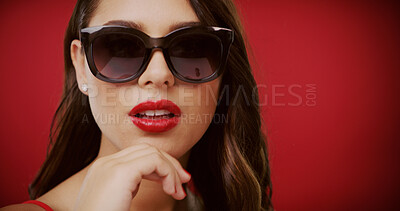 Buy stock photo Makeup, sunglasses and face of woman in studio for fashion, trendy style and cosmetics. Space, designer aesthetic and confident person with accessories, beauty and red lipstick on color background