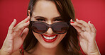 Happy, sunglasses and portrait of woman in studio for fashion, trendy style and cosmetics. Beauty, aesthetic and face of confident person with accessories, makeup and red lipstick on color background