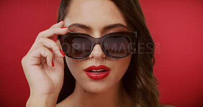 Buy stock photo Beauty, sunglasses and face of woman in studio for fashion, trendy style and cosmetics. Space, designer aesthetic and confident person with accessories, makeup and red lipstick on color background