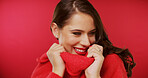 Smile, lipstick and woman in studio with fashion, beauty and cosmetology on red background. Happy, female person and model with makeup, smile and luxury cosmetics for aesthetic and glow and space