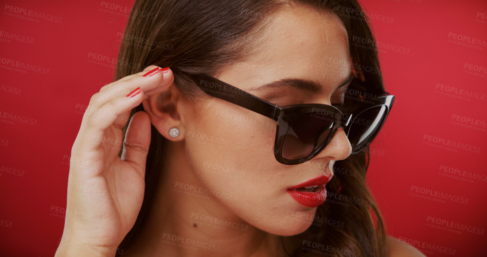 Buy stock photo Accessories, fashion and sunglasses with woman on red background for style or UV protection. Face, makeup and trendy with confident model isolated on studio space for advertising or marketing shades