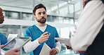 Man, nurse and talking to team in hospital for planning, medical report and surgery schedule. People, listen and folder for brainstorming, operation feedback and patient charts for treatment results