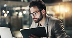Business, man and tablet with laptop in office for market data comparison, trading and research. Overtime, night trader and digital tech for economy news, investment account or search currency prices