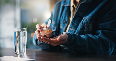 Buy stock photo Water, pills and hands of man in home for medical treatment, prescription and tablets for recovery. House, health and person with medication container for vitamins, supplements and drugs on table