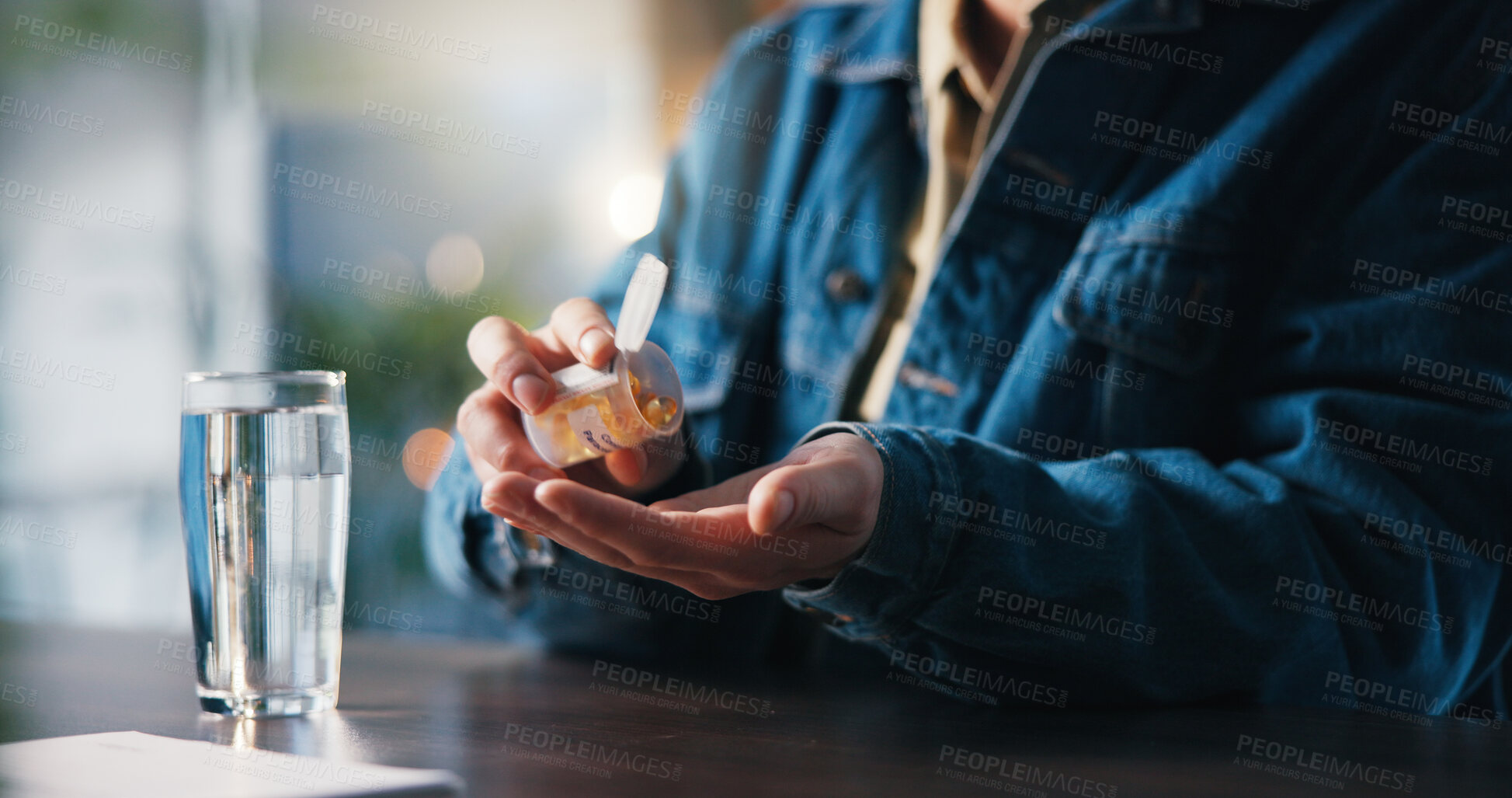 Buy stock photo Water, pills and hands of man in home for medical treatment, prescription and tablets for recovery. House, health and person with medication container for vitamins, supplements and drugs on table