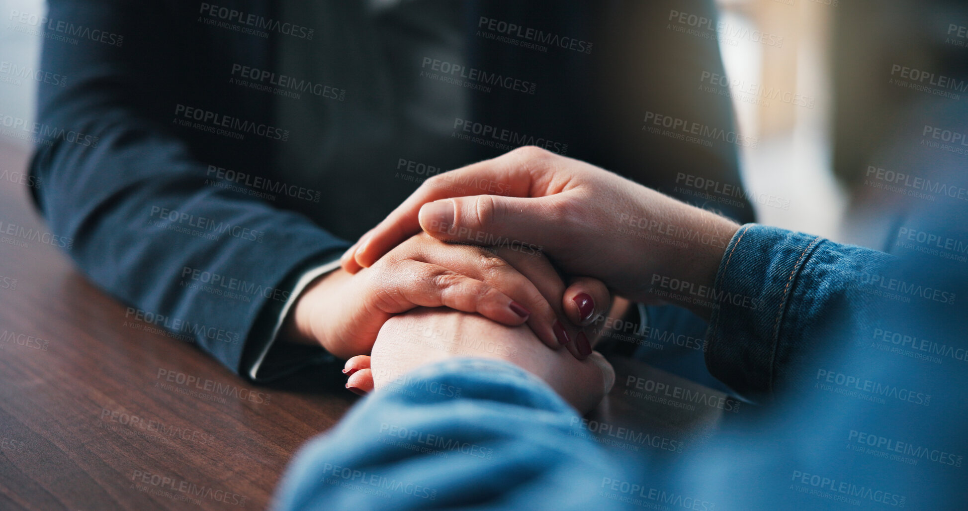 Buy stock photo Holding hands, table and couple in home for love, empathy and bonding for support. Relationship, counseling and above of people together for connection, affection and care for commitment in house
