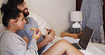 Eating, laptop and couple with pizza on bed watching movie, series or show together on weekend. Happy, home and man with woman for enjoying takeout food with computer for streaming film in bedroom.