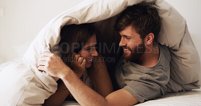 Buy stock photo Home, blanket and couple in bedroom, love and bonding together with happiness, care and relax. Duvet, apartment and man with woman, relationship and comfort with marriage, playful and commitment