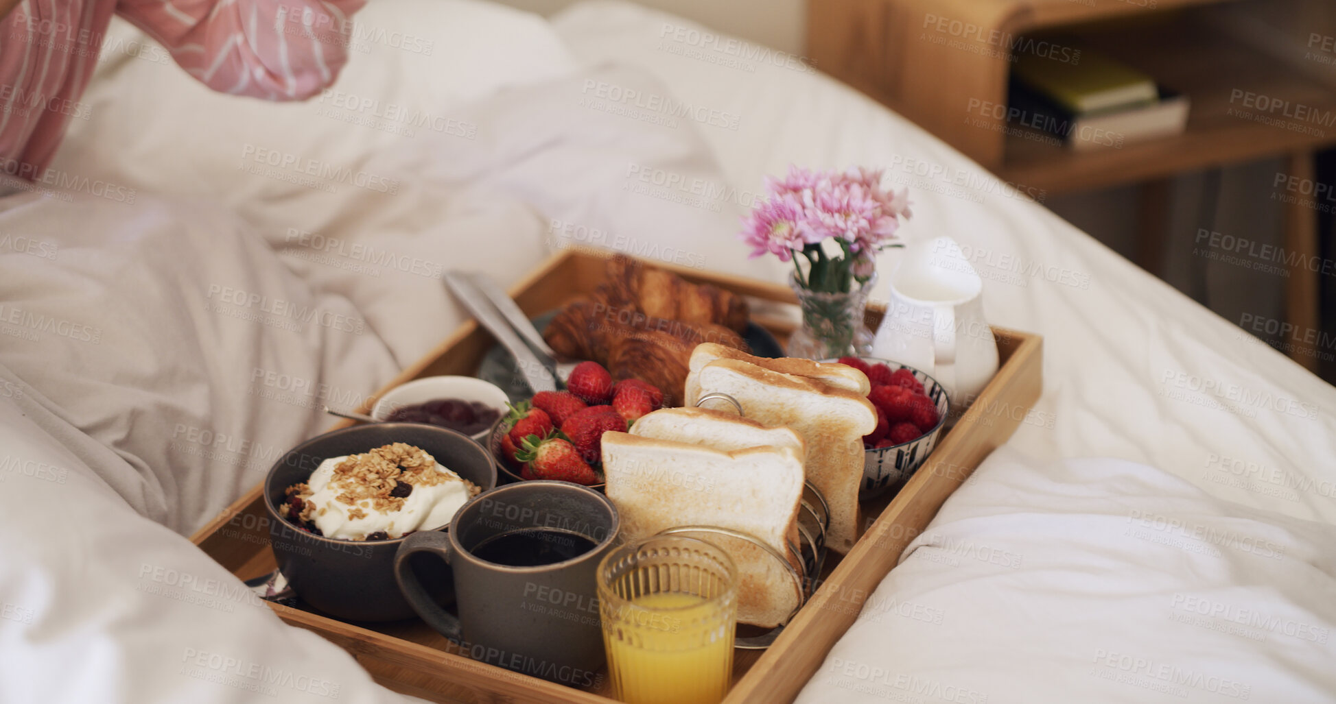 Buy stock photo Person, food tray and bed with breakfast for healthy diet, anniversary or room service. Morning, meal and fruit with juice, toast or cereal in bedroom for valentines day, catering or accommodation
