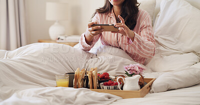 Buy stock photo Cellphone, photography and woman with breakfast in bed for hospitality, room service or meal in hotel. Phone, relax and person with morning food on tray with picture for social media at accommodation
