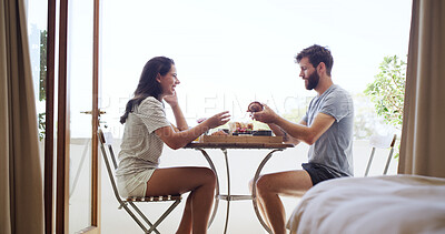 Buy stock photo Breakfast, morning and smile with couple on balcony of home together for bonding or hunger. Eating, happy and love with people outdoor at apartment for anniversary, honeymoon or romantic meal