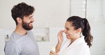 Buy stock photo Skincare, cream and funny with couple in bathroom for beauty, support and sunscreen protection. Cosmetics, laughing and dermatology with man and woman in home for uv lotion, glow and spf product