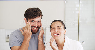 Buy stock photo Laughing, portrait and skincare with couple in bathroom of home together for moisturizing routine. Beauty, cream and lotion with funny people in mirror at apartment to antiaging cosmetics to face