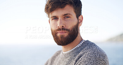 Buy stock photo Portrait, travel and man at ocean for vacation, summer trip or adventure with space. Beach, tourist and serious person at outdoor with confidence on holiday at sea on tropical island in Greece