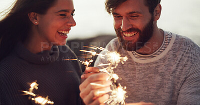 Buy stock photo Happy couple, celebration and anniversary with sparklers for new year, outdoor party or memory. Man, woman or playing with fireworks, smile or moment for festive holiday, date or weekend together