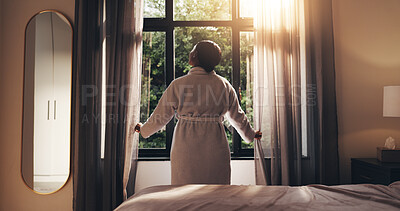Buy stock photo Morning, window and back of woman in bedroom of home for wake up, peace and reflection. Lens flare, sunrise and wellness with female person opening curtains in apartment for calm, relax and energy