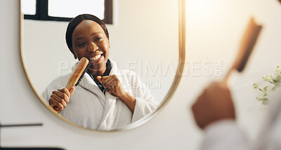 Buy stock photo Black woman, brush and singing at bathroom mirror, voice and laugh with morning routine at home. African person, reflection and happy with song, grooming and hair care with energy for music at house