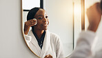 Cotton pad, mirror and black woman with skincare, cosmetics and smile in bathroom. Home, reflection and African person with dermatology, wellness and grooming with healthy skin and makeup removal