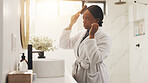 Mirror, bathroom and black woman with hairbrush in home for grooming, hygiene and routine. Sunlight, morning routine and person with reflection for beauty, self care and healthy texture for growth