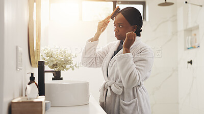 Buy stock photo Mirror, bathroom and black woman with hairbrush in home for grooming, hygiene and wellness. Sunlight, morning routine and person with reflection for beauty, self care and healthy texture for growth