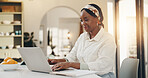 Laptop, research and black woman in kitchen in home with remote work for creative project. Happy, computer and African female editor with freelance job for online article publishing in apartment.