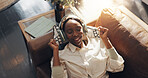 Happy, woman and music with headphones, home and relax on couch, comfortable and listening to audio. Resting, black person and streaming song on website, dance and subscription to app for playlist