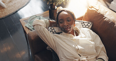 Above, relax and black woman on sofa, thinking and calm with weekend break, peace and daydreaming. Apartment, choice or African person on couch, decision and thoughtful with wonder, home or wellness