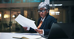 Business, woman or serious with paperwork in office for financial review, invoices or compliance risk. Bookkeeper, mature person and laptop with statements for budget forecasting, payroll and night