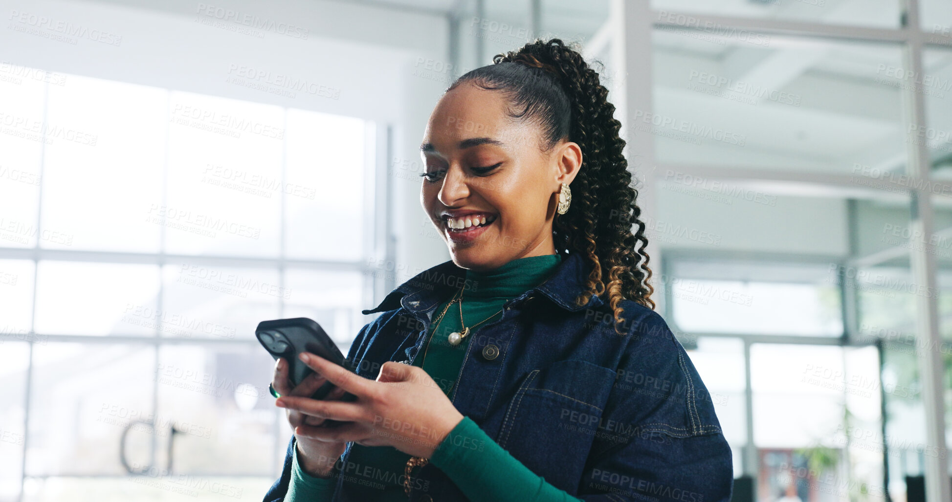Buy stock photo Woman, phone and happy with texting at startup, scroll and notification for deal at media company. Person, smartphone and smile on break at office, web chat and social network at creative agency