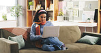 Laptop, relax and woman on sofa in home with typing for university assignment in living room. Education, computer and female student with research for college project, study or online test in house.