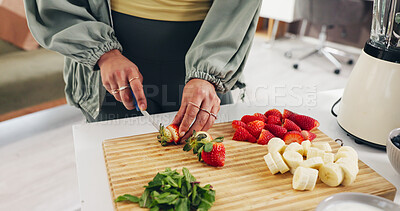 Buy stock photo Person, hands and meal prep with fruit ingredients for diet or natural organic food in home. Closeup, nutritionist or cutting strawberries with knife on chopping board for healthy recipe or smoothie