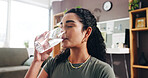 Woman, drinking and water with glass in home for hydration, thirst or natural sustainability. Female person, relax and mineral liquid with cool beverage for fitness break, rest or recovery in house