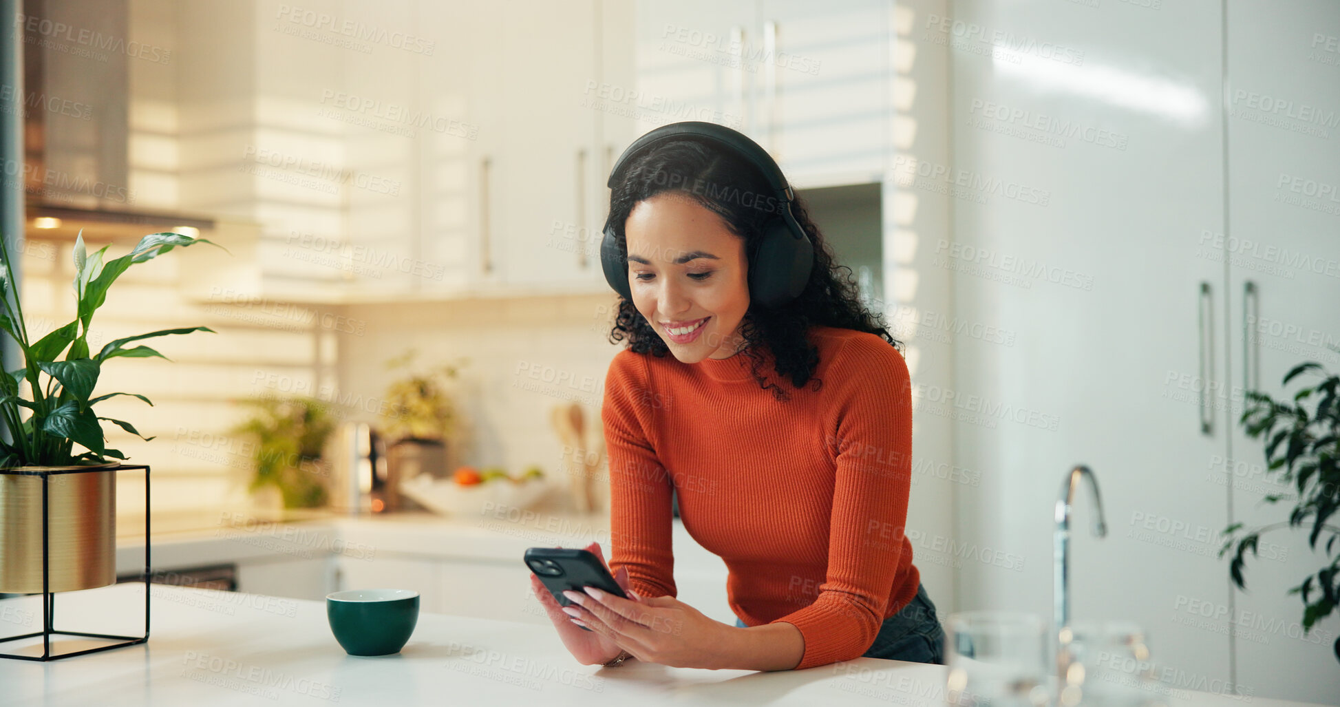 Buy stock photo Phone, music and coffee with woman in kitchen for streaming service, radio and smile. Podcast subscription, relax and happy with female person and tea in home for headphones, audio and mobile