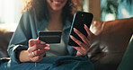 Hands, phone and credit card on sofa with online shopping, sale and easy payment on web in home. Person, smartphone and digital banking on mobile app, fintech or discount deal with ecommerce at house