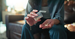 Hands, home and woman on sofa, pills and container with medical treatment, illness and dosage. Closeup, apartment and person with prescription, tablets and chronic patient with pharmaceutical care